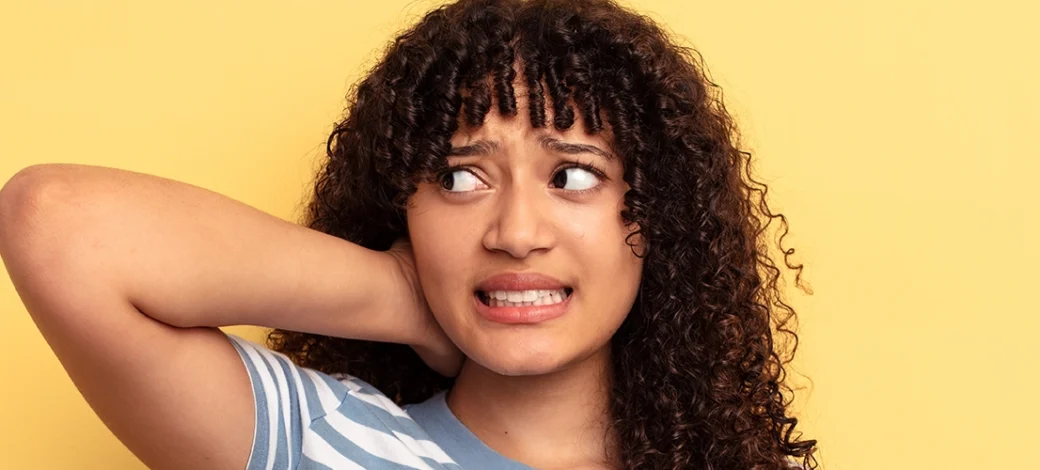An egg donor with a confused expression wondering if egg donation is painful.