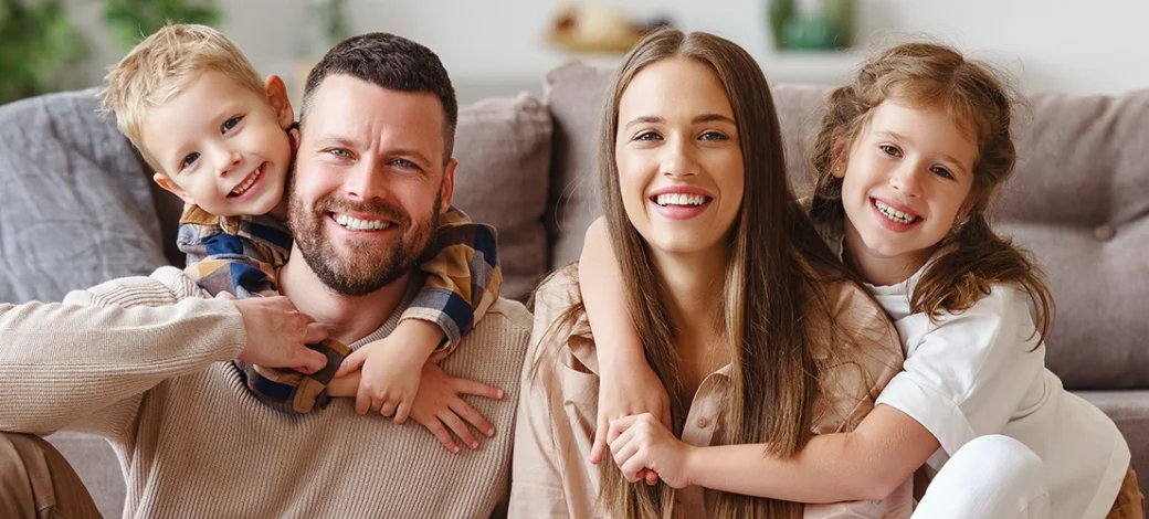 A smiling family happy with their decision to use donor eggs.