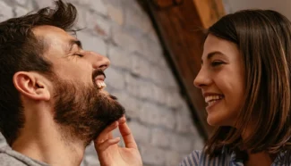 A happy couple smiling about being parents through egg donation.