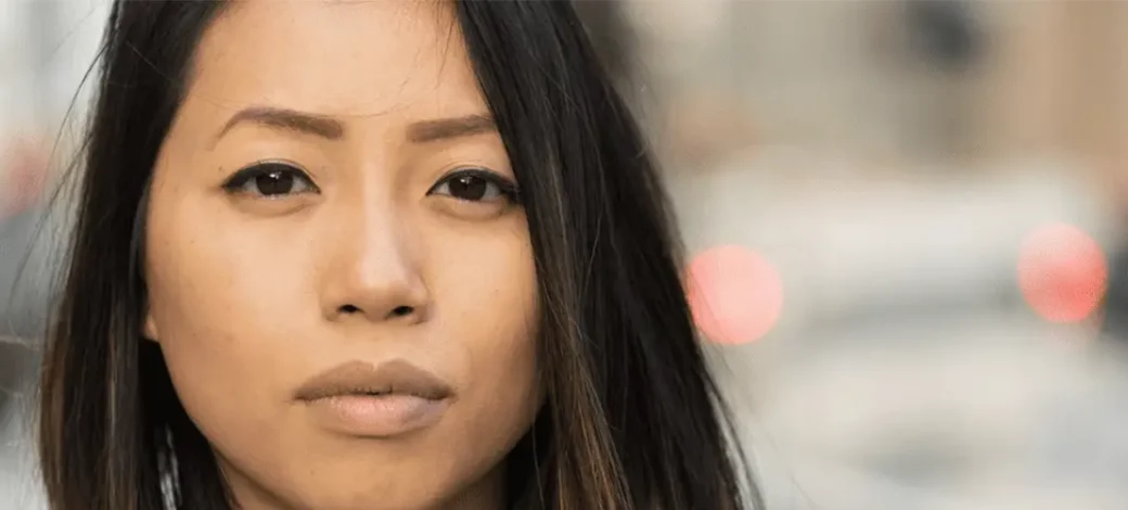 Woman looking longingly and feeling regret about her egg donation.