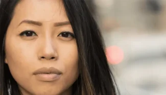 Woman looking longingly and feeling regret about her egg donation.