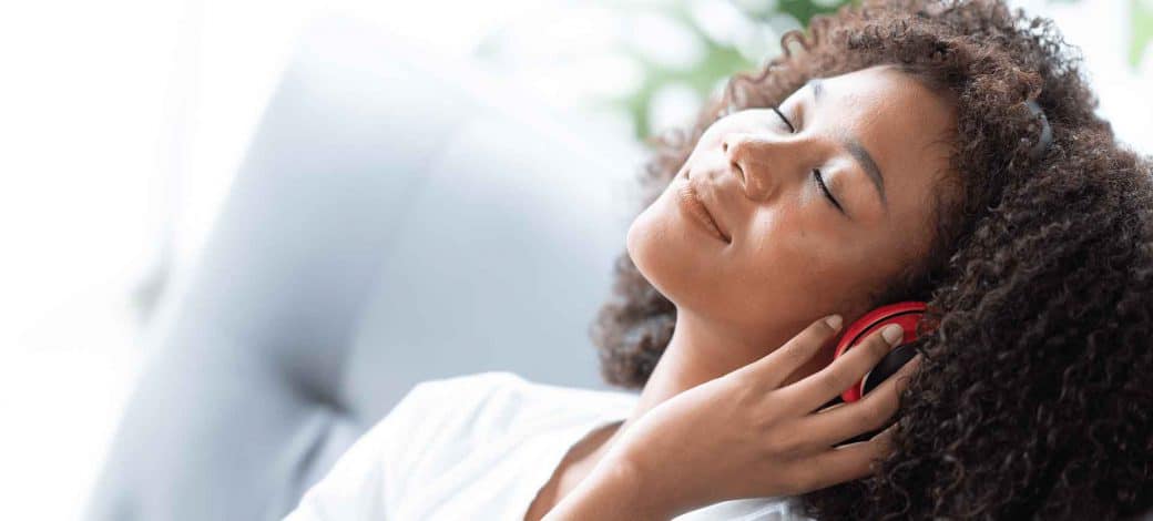 A woman leaning back and thinking about egg donor age requirements.