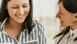 An egg donor and her doctor talking about fertility drugs.