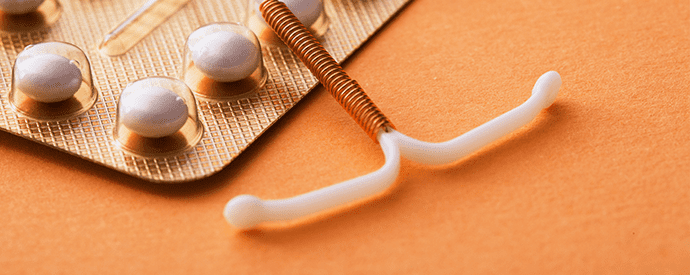 IUD and Birth Control Pills on Table
