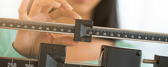 Woman Checking Weight on Scale for Egg Donation BMI