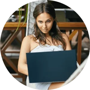 Beautiful woman in hammock with laptop